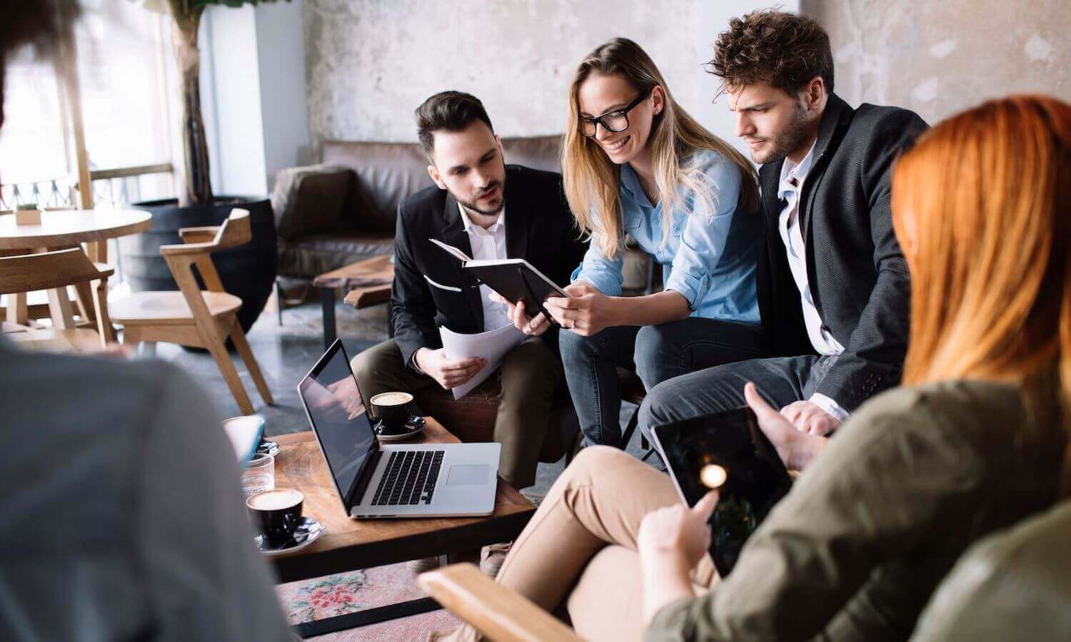 team sitting in common area in meeting