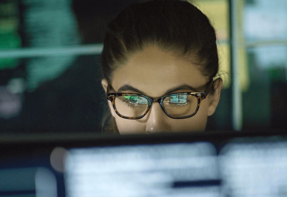 woman looking at computer screen through glasses copy