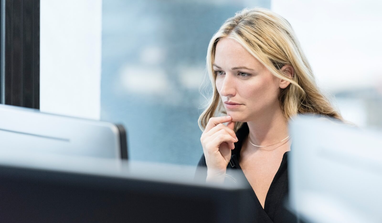 Woman looking seriously at desktop computer