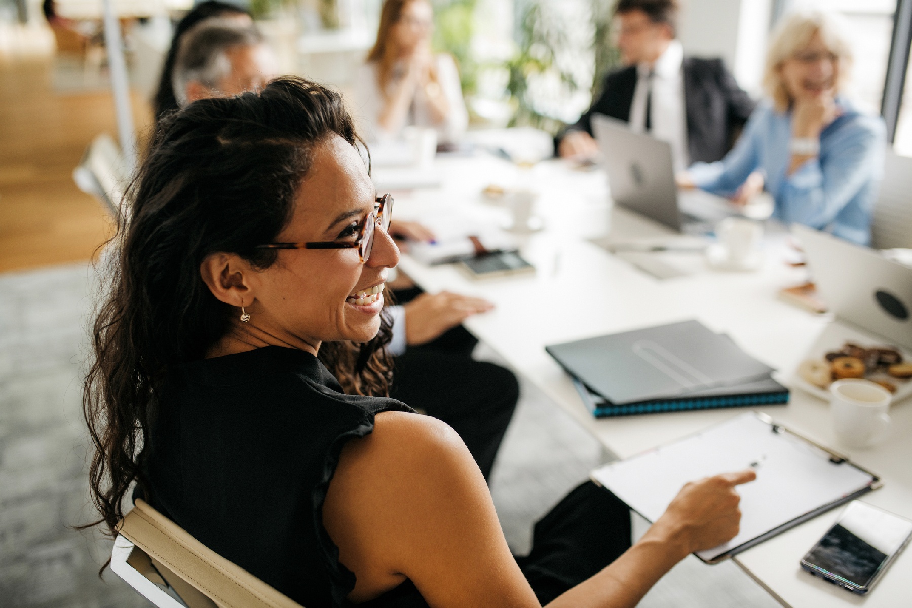 Woman smiling in office meeting