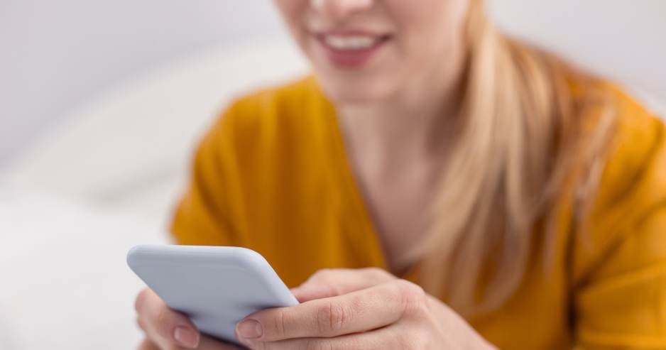 Woman using her mobile phone to send unsecured email