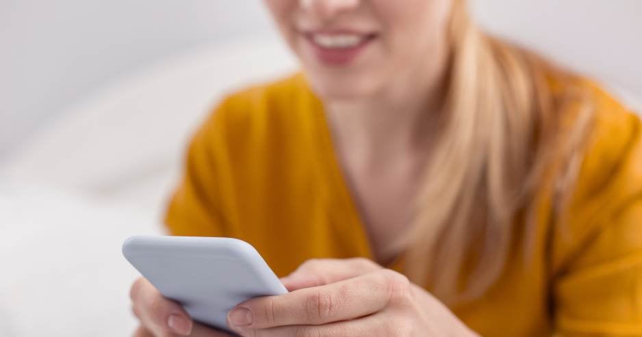 woman using mobile phone to send unsecured email