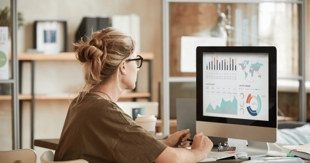 Woman working on graphics at desk in her home office